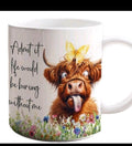 A white ceramic mug featuring a cartoon illustration of a fluffy brown Highland cow with a yellow butterfly on its head, surrounded by colorful wildflowers and the text 'Admit it life would be boring without me'.