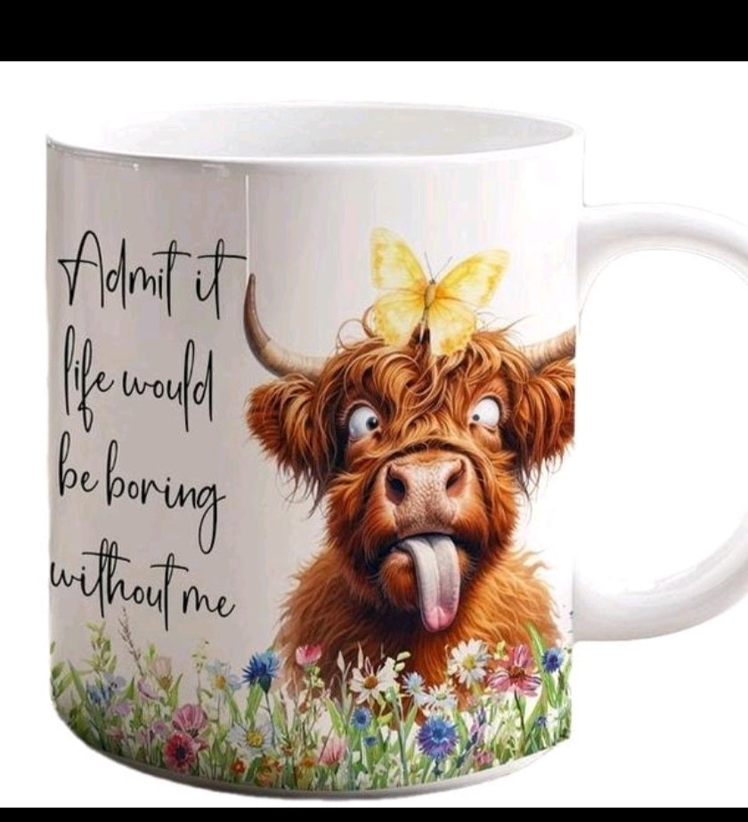A white ceramic mug featuring a cartoon illustration of a fluffy brown Highland cow with a yellow butterfly on its head, surrounded by colorful wildflowers and the text 'Admit it life would be boring without me'.