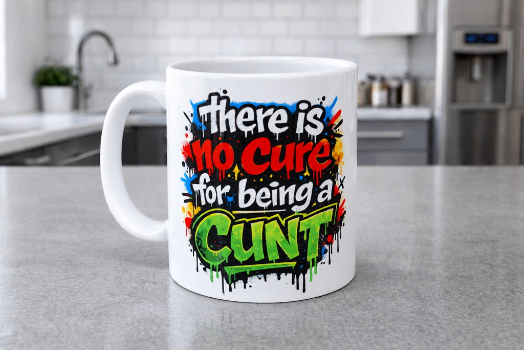 A white ceramic coffee mug with a colorful graffiti-style graphic that reads 'There is no Cure for being a CUNT' in red, green, blue, yellow, and black lettering, set on a gray kitchen countertop with a blurred kitchen background.